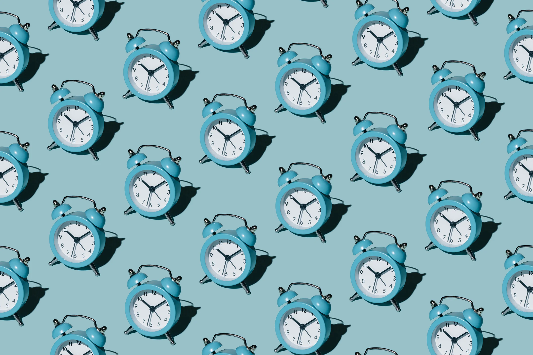 Pattern of alarm clocks on a blue background