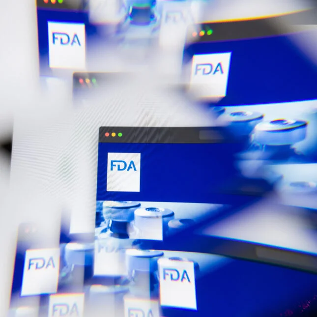 FDA logo on laptop screen seen through an optical prism. -- coverage from STAT