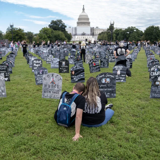 People who lost relatives to a drug overdose sit among imitation graves set up by the Trail of Truth, near the US Capitol. -- first opinion coverage from STAT