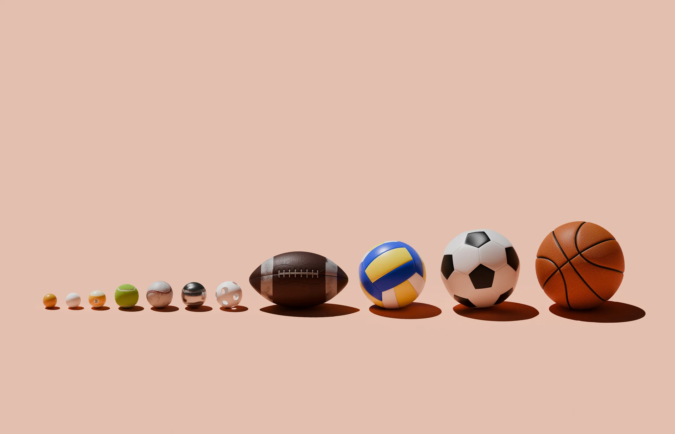 Various sports balls in a row